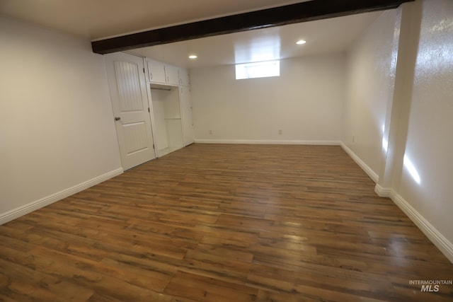 basement with dark hardwood / wood-style floors