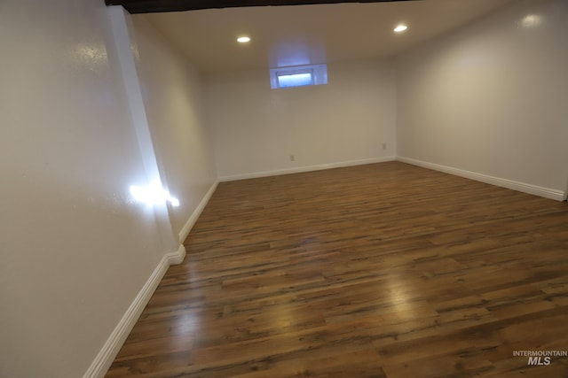 basement with dark wood-type flooring