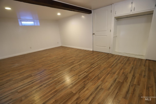 basement with dark hardwood / wood-style flooring