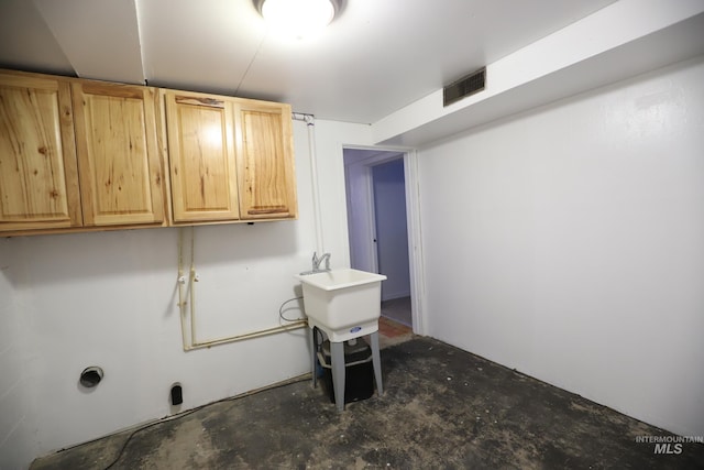 laundry room featuring cabinets