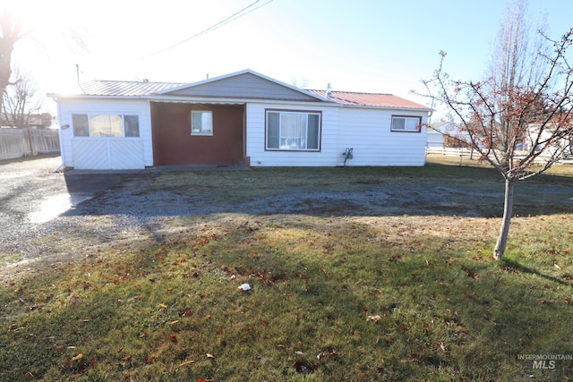 rear view of house with a yard