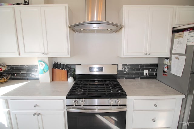 kitchen with white cabinets, island exhaust hood, stainless steel appliances, and decorative backsplash