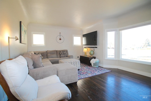 living area with dark wood-style flooring and baseboards