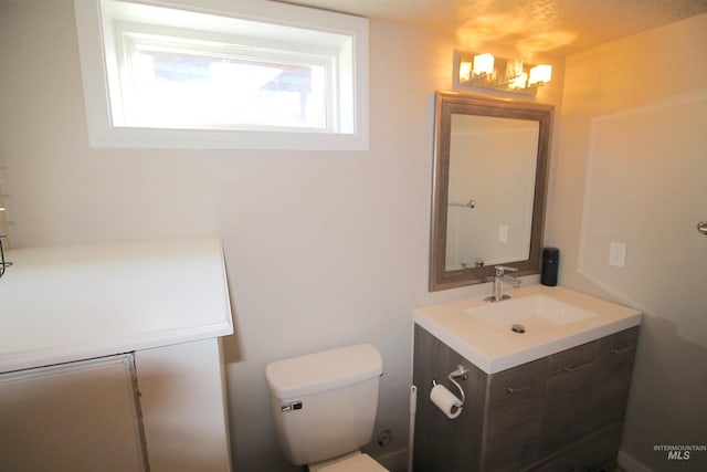 bathroom with toilet and vanity