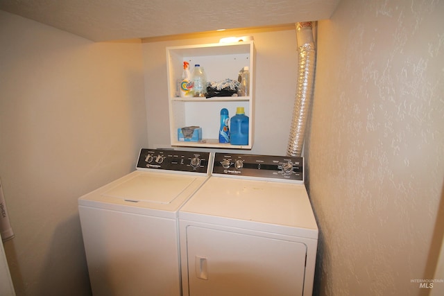 laundry room featuring a textured ceiling, laundry area, and independent washer and dryer