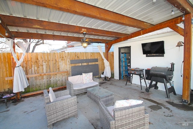 view of patio with fence, a ceiling fan, and a grill