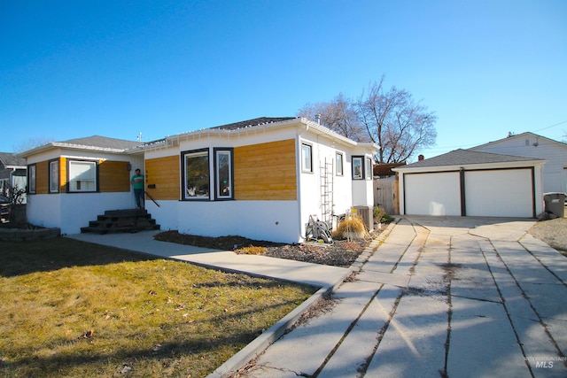 view of front of house with a garage and a front lawn