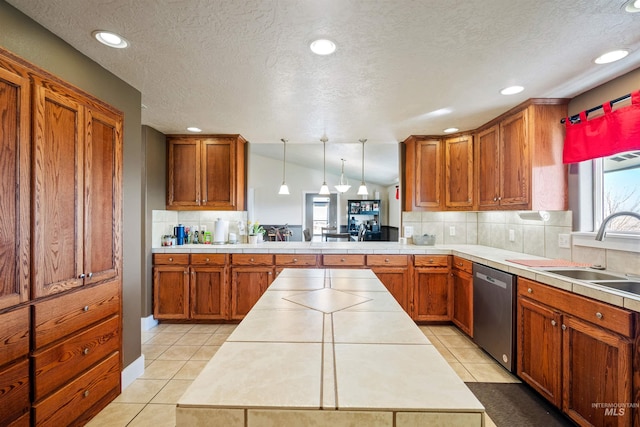 kitchen featuring a sink, stainless steel dishwasher, brown cabinetry, and light tile patterned floors