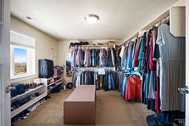 walk in closet featuring visible vents and carpet floors