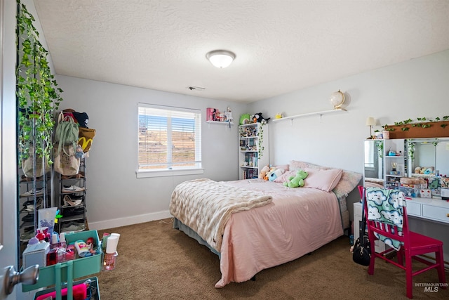 carpeted bedroom featuring visible vents, baseboards, and a textured ceiling