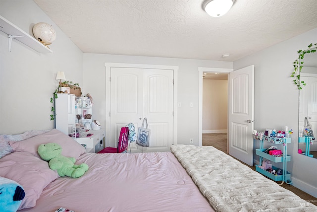 bedroom with baseboards, a closet, and a textured ceiling