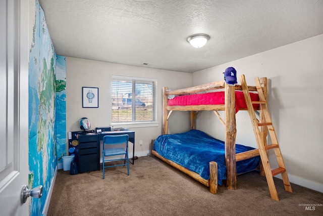 carpeted bedroom with baseboards and a textured ceiling