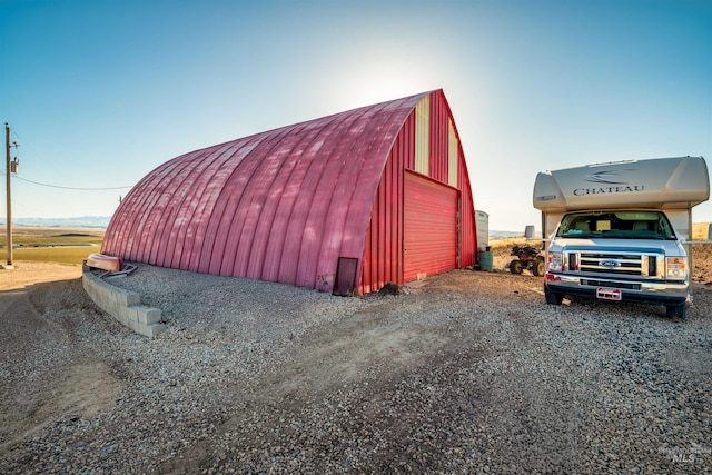 view of outbuilding featuring an outbuilding and driveway