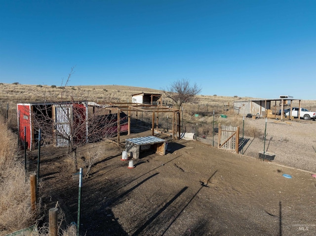 view of yard featuring an outbuilding and fence