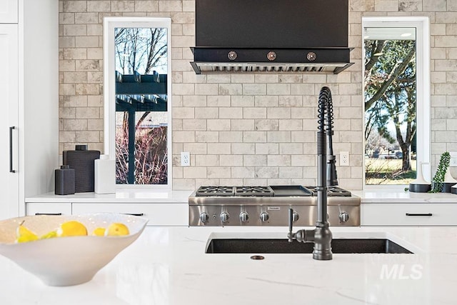 1458 W Sandy Ct, Meridian, ID 83646 - kitchen featuring exhaust hood, white cabinetry, and light stone countertops