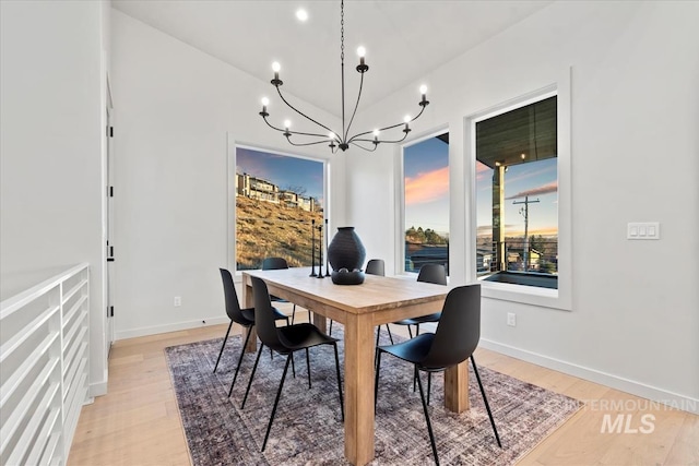 dining space featuring a chandelier and light wood-type flooring