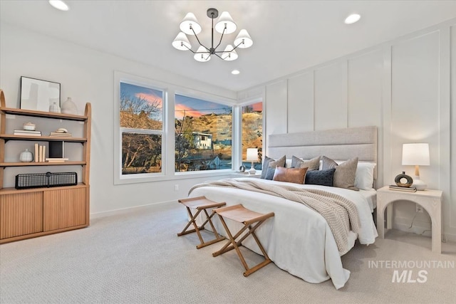 carpeted bedroom featuring a chandelier