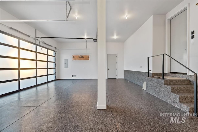 garage featuring a garage door opener and electric panel