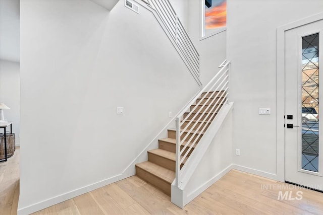 stairway featuring hardwood / wood-style floors