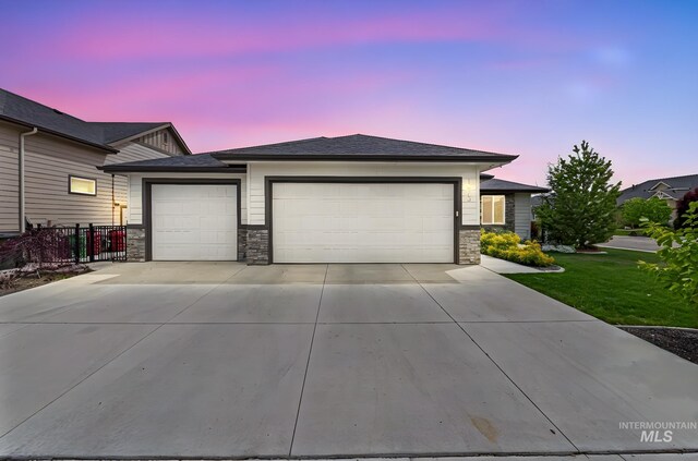 1073 W Smoky Quartz St, Kuna, ID 83634 - view of front of house with an attached garage, driveway, and stone siding