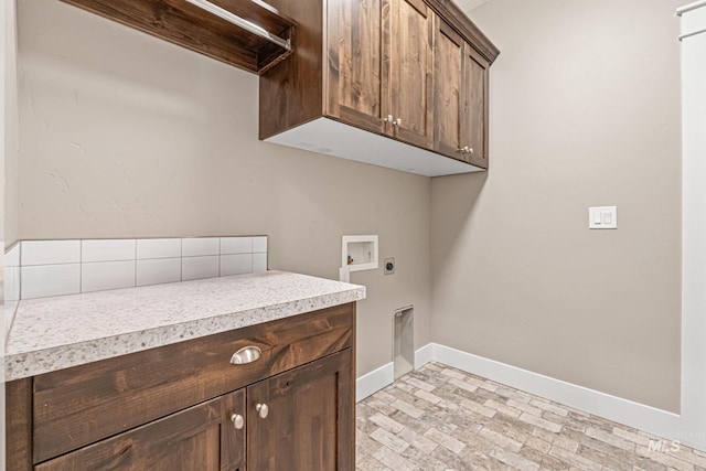 1073 W Smoky Quartz St, Kuna, ID 83634 - laundry room with cabinet space, electric dryer hookup, baseboards, washer hookup, and brick patterned floors