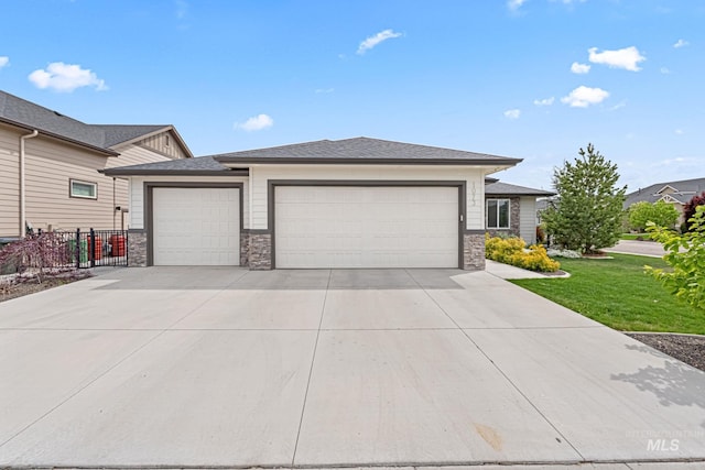 1073 W Smoky Quartz St, Kuna, ID 83634 - prairie-style home with stone siding, an attached garage, concrete driveway, and roof with shingles