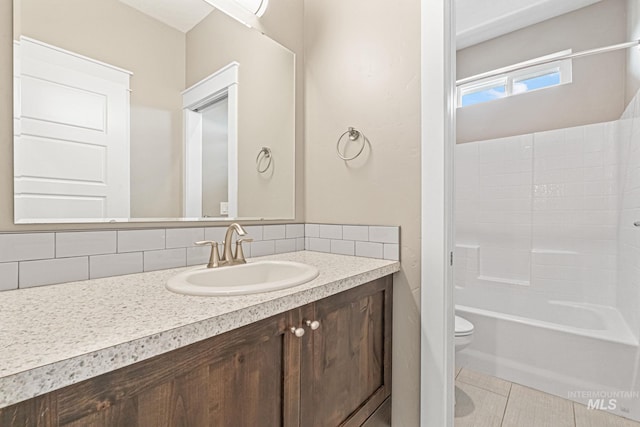 1073 W Smoky Quartz St, Kuna, ID 83634 - bathroom with toilet, vanity, backsplash, and tile patterned floors