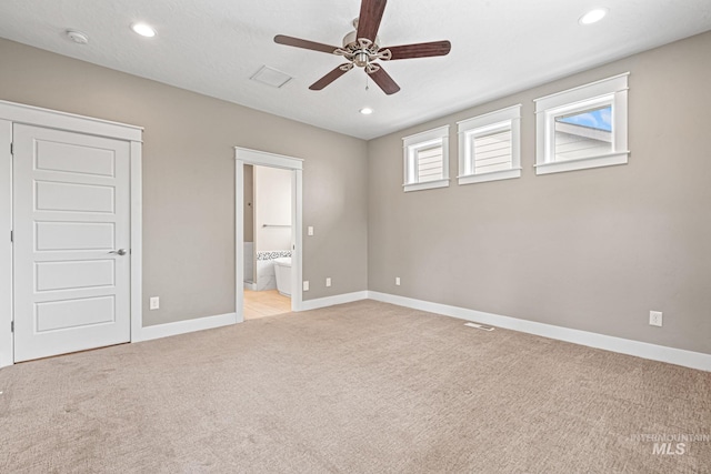 1073 W Smoky Quartz St, Kuna, ID 83634 - unfurnished bedroom featuring light colored carpet, baseboards, recessed lighting, ensuite bathroom, and ceiling fan