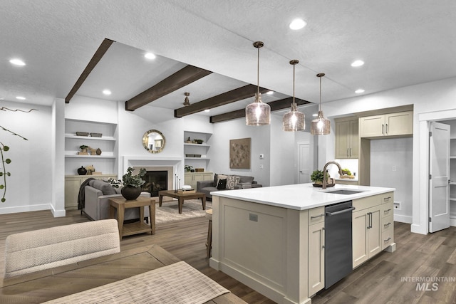6251 S Utmost Ln, Meridian, ID 83642 - kitchen featuring stainless steel dishwasher, open floor plan, beamed ceiling, a kitchen island with sink, and a fireplace