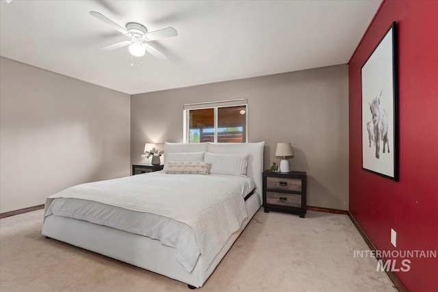 bedroom with light colored carpet, baseboards, and ceiling fan