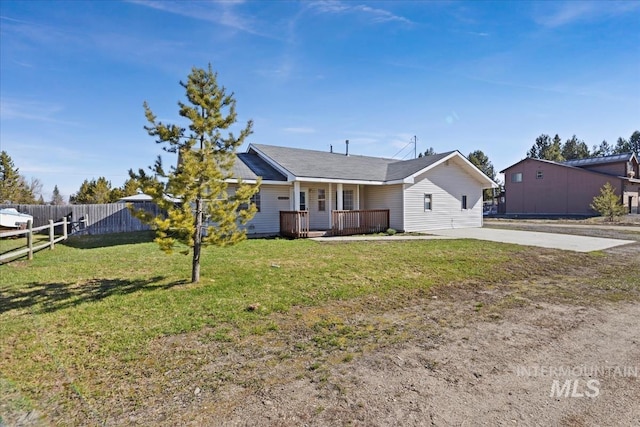 single story home with fence, covered porch, concrete driveway, and a front lawn