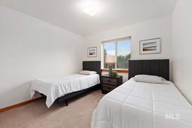 bedroom featuring baseboards and carpet