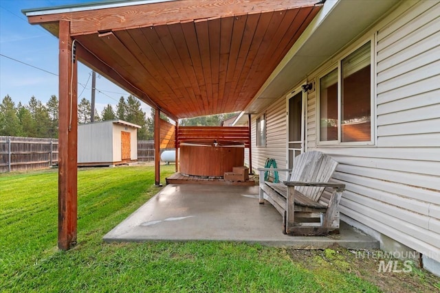 view of patio / terrace featuring an outdoor structure, a fenced backyard, and a shed