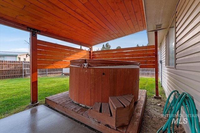 view of patio / terrace featuring a fenced backyard, a hot tub, and visible vents