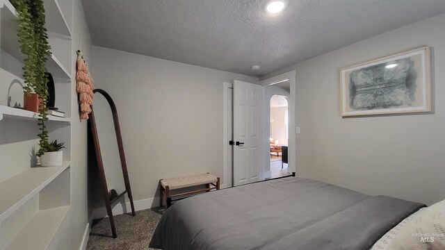 1101 Clithero Dr, Boise, ID 83703 - bedroom featuring arched walkways, carpet flooring, a textured ceiling, and baseboards