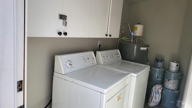 1101 Clithero Dr, Boise, ID 83703 - clothes washing area featuring water heater, washing machine and clothes dryer, and cabinet space