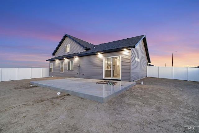 507 Jesse Ave, Twin Falls, ID 83301 - back of property at dusk featuring a fenced backyard and a shingled roof