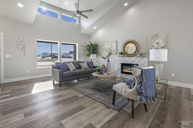 507 Jesse Ave, Twin Falls, ID 83301 - living room featuring ceiling fan, a high end fireplace, baseboards, a towering ceiling, and recessed lighting