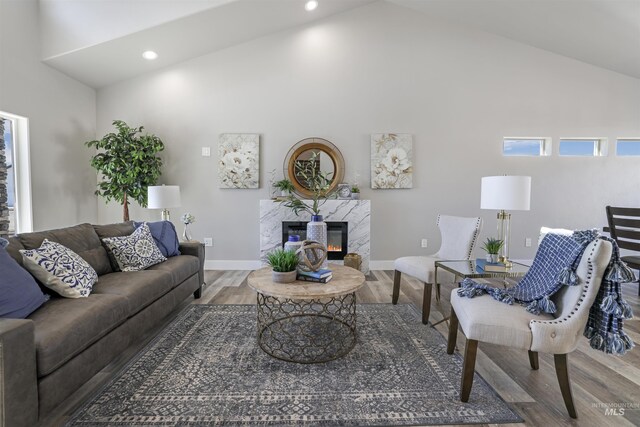 507 Jesse Ave, Twin Falls, ID 83301 - living room with wood finished floors, a high end fireplace, high vaulted ceiling, baseboards, and recessed lighting