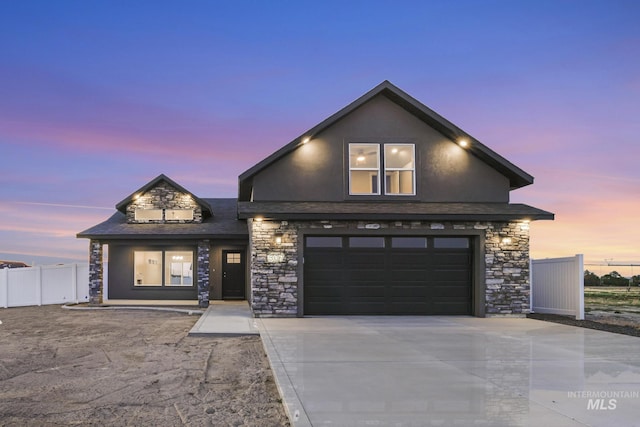 507 Jesse Ave, Twin Falls, ID 83301 - view of front of property with stone siding, driveway, a garage, stucco siding, and a shingled roof