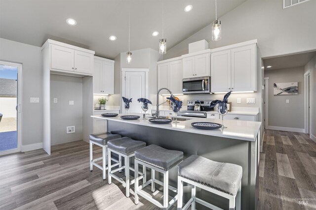507 Jesse Ave, Twin Falls, ID 83301 - kitchen with stainless steel appliances, light countertops, white cabinets, dark wood-style floors, and pendant lighting