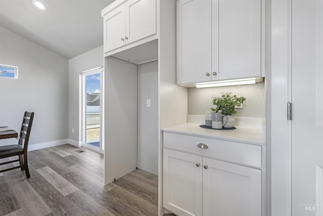 507 Jesse Ave, Twin Falls, ID 83301 - kitchen with wood finished floors, white cabinets, lofted ceiling, light countertops, and recessed lighting