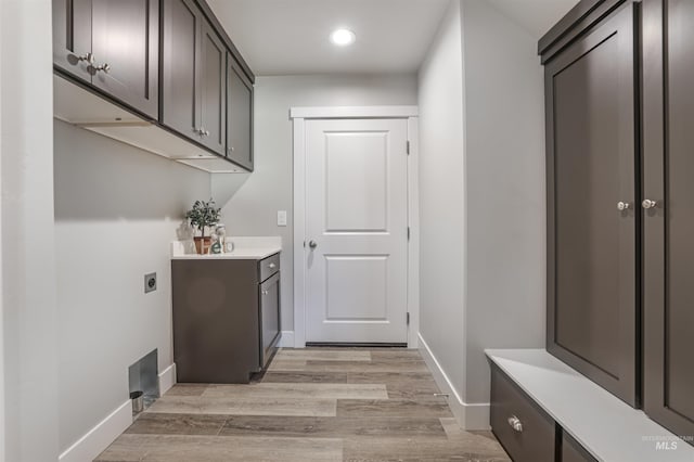 507 Jesse Ave, Twin Falls, ID 83301 - washroom with electric dryer hookup, baseboards, recessed lighting, light wood-type flooring, and cabinet space