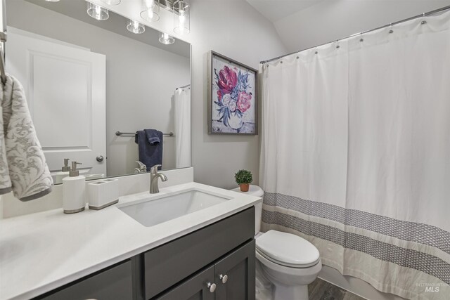 507 Jesse Ave, Twin Falls, ID 83301 - full bathroom featuring vanity, toilet, wood finished floors, and shower / bath combination with curtain