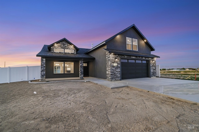 507 Jesse Ave, Twin Falls, ID 83301 - view of front facade with stone siding, driveway, a garage, and stucco siding