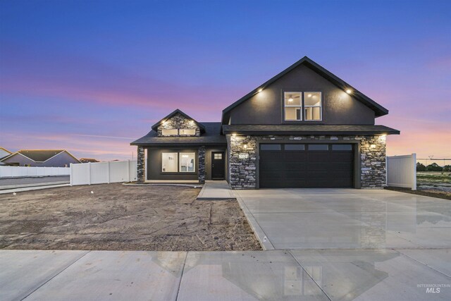 507 Jesse Ave, Twin Falls, ID 83301 - view of front of home with stone siding, concrete driveway, an attached garage, and stucco siding