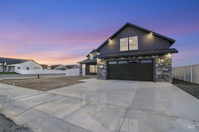 507 Jesse Ave, Twin Falls, ID 83301 - view of front of home featuring stone siding, stucco siding, concrete driveway, and an attached garage