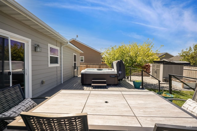449 View Ave, Twin Falls, ID 83301 - view of patio with a hot tub, a wooden deck, a storage shed, a fenced backyard, and an outdoor structure