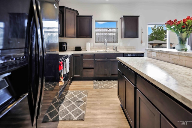 449 View Ave, Twin Falls, ID 83301 - kitchen with a sink, black refrigerator with ice dispenser, light wood-type flooring, and light countertops