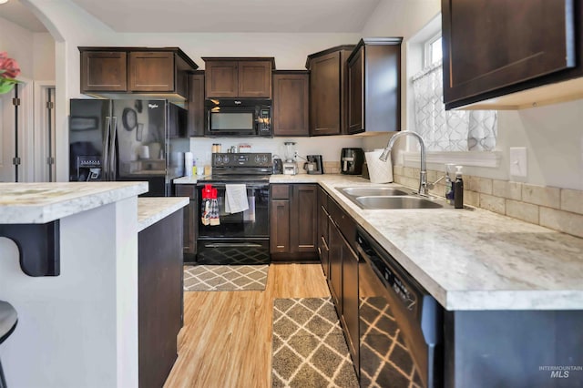 449 View Ave, Twin Falls, ID 83301 - kitchen featuring black appliances, a sink, dark brown cabinetry, light countertops, and light wood finished floors